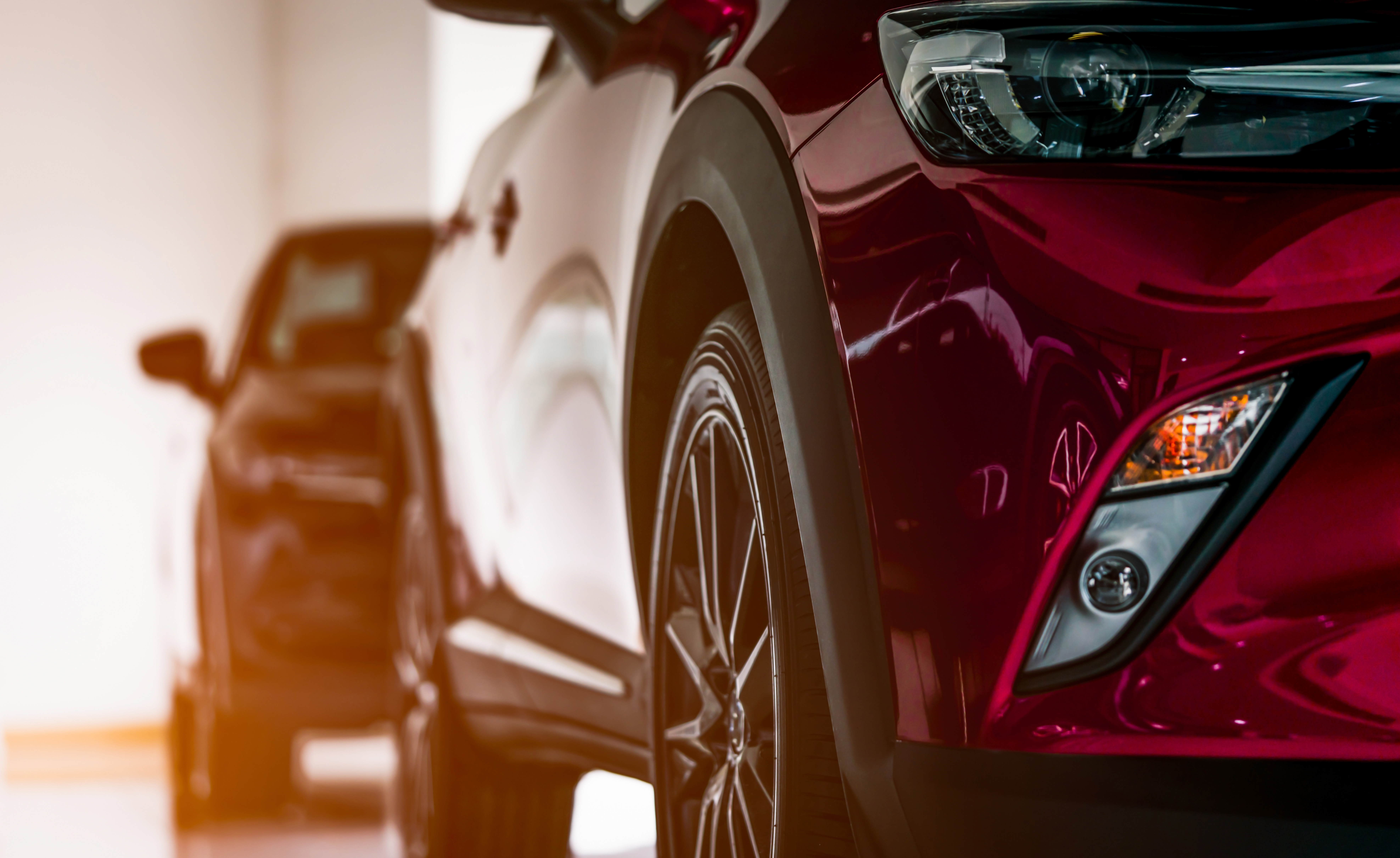 New luxury SUV compact car parked in modern showroom for sale. Car dealership office. Car retail shop. Electric car technology and business concept